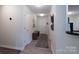 Hallway featuring wood floors, a bench, and a doorway at 744 Chipmeadow Ln, York, SC 29745