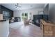 Spacious living area with dark accent wall, fireplace, sliding glass door, and adjoining kitchen at 744 Chipmeadow Ln, York, SC 29745