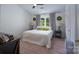 Bright main bedroom features a bed, bedside tables, and gray curtains at 744 Chipmeadow Ln, York, SC 29745