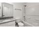 Bright bathroom features a granite countertop, white cabinetry, and a shower over tub combo at 7616 Monarch Birch Ln, Charlotte, NC 28215