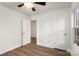 Bedroom with neutral walls, wood-look flooring, and closet space, perfect for relaxation at 7616 Monarch Birch Ln, Charlotte, NC 28215