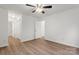 A spacious bedroom features a ceiling fan, laminate floors, and access to the bathroom at 7616 Monarch Birch Ln, Charlotte, NC 28215