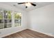Bright bedroom with two windows and wood-look floors, creating a cozy space at 7616 Monarch Birch Ln, Charlotte, NC 28215
