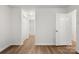 A bedroom shows laminate floors, access to the bathroom, and a closet with sliding doors at 7616 Monarch Birch Ln, Charlotte, NC 28215