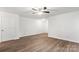 Bright bedroom featuring hard surface floors, ceiling fan, and neutral walls at 7616 Monarch Birch Ln, Charlotte, NC 28215