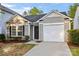 Charming single story house with a white garage door and a well-maintained front yard at 7616 Monarch Birch Ln, Charlotte, NC 28215