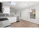 Open kitchen features white cabinets, granite countertops, and stainless steel appliances at 7616 Monarch Birch Ln, Charlotte, NC 28215