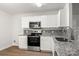 Modern kitchen featuring stainless steel appliances, granite countertops, and neutral color scheme at 7616 Monarch Birch Ln, Charlotte, NC 28215