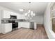 Modern kitchen featuring white cabinets, granite countertops, and stainless steel appliances at 7616 Monarch Birch Ln, Charlotte, NC 28215