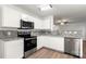 Well-appointed kitchen featuring stainless steel appliances, granite countertops, and bright white cabinets at 7616 Monarch Birch Ln, Charlotte, NC 28215