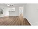 Open-concept living room features wood-look flooring, neutral walls, and natural light at 7616 Monarch Birch Ln, Charlotte, NC 28215