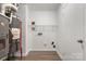 This utility room includes a water heater, furnace, laminate flooring, and shelving at 7616 Monarch Birch Ln, Charlotte, NC 28215