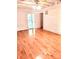 Bedroom featuring hardwood floors and log-cabin style whitewashed walls at 7811 Babe Stillwell Farm Rd, Huntersville, NC 28078