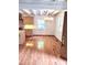 An eat-in dining area has a log wall and hardwood floors adjacent to kitchen at 7811 Babe Stillwell Farm Rd, Huntersville, NC 28078