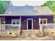 Charming single-story home with stone foundation, covered front porch, and dark wood siding at 7811 Babe Stillwell Farm Rd, Huntersville, NC 28078