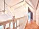 Upstairs hallway featuring log-cabin style whitewashed walls and hardwood floors at 7811 Babe Stillwell Farm Rd, Huntersville, NC 28078