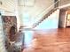 Living room with fireplace, staircase, wood floors, and natural light at 7811 Babe Stillwell Farm Rd, Huntersville, NC 28078