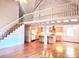 Spacious living room with hardwood floors, white-painted logs, and a kitchen view at 7811 Babe Stillwell Farm Rd, Huntersville, NC 28078