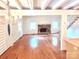 Spacious living room with a stone fireplace, hardwood floors, and open layout at 7811 Babe Stillwell Farm Rd, Huntersville, NC 28078