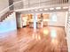 Expansive living area showcases hardwood floors, open layout, and a view of the kitchen at 7811 Babe Stillwell Farm Rd, Huntersville, NC 28078