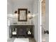 Bathroom featuring a granite-topped vanity with a dark wood base, sconces, and a view into the glass-enclosed shower at 7906 Skye Lochs Dr, Waxhaw, NC 28173