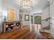 Spacious foyer boasting hardwood floors, a decorative chandelier, and an adjacent staircase at 7906 Skye Lochs Dr, Waxhaw, NC 28173