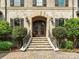 Grand entrance featuring stone steps, ornate iron doors, and meticulously maintained shrubbery at 7906 Skye Lochs Dr, Waxhaw, NC 28173