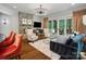 Elegant living room with a stone fireplace, a crystal chandelier, and large glass doors to the backyard at 7906 Skye Lochs Dr, Waxhaw, NC 28173