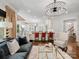Bright open-concept living room flowing into a modern kitchen with a chandelier and large windows at 7906 Skye Lochs Dr, Waxhaw, NC 28173