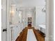 Elegant main bathroom with double vanity, soaking tub, chandelier, and access to a large walk-in closet at 7906 Skye Lochs Dr, Waxhaw, NC 28173