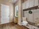 Inviting mudroom featuring a custom built-in bench and storage, accented by wood planked walls and floors at 7906 Skye Lochs Dr, Waxhaw, NC 28173