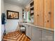 Charming home office with custom wooden floors, built-in shelving, desk, and bright natural light at 7906 Skye Lochs Dr, Waxhaw, NC 28173