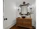 Stylish powder room featuring a beautiful mirror, sconces, and a unique wooden vessel sink on a dresser at 7906 Skye Lochs Dr, Waxhaw, NC 28173