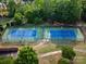 Aerial view of neighborhood tennis courts surrounded by mature trees at 7906 Skye Lochs Dr, Waxhaw, NC 28173
