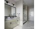 Modern bathroom with double vanity, sleek fixtures, walk-in shower with glass door, and tile flooring at 808 Garringer Pl, Charlotte, NC 28208