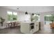 Modern kitchen with an island, stainless steel appliances, marble countertops, and a dining area with natural light at 808 Garringer Pl, Charlotte, NC 28208