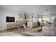 Bright open-plan living room and kitchen featuring modern decor, stainless steel appliances, and a cozy dining area at 808 Garringer Pl, Charlotte, NC 28208