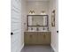 Elegant bathroom featuring a double vanity with stone countertops, stylish lighting, and modern fixtures at 817 Garringer Pl, Charlotte, NC 28208