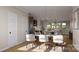 Open-concept dining area featuring seating for six, flowing seamlessly into the modern kitchen at 817 Garringer Pl, Charlotte, NC 28208