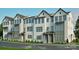 New construction townhomes boast a modern facade with white siding, brick accents, and complementary gray trim at 817 Garringer Pl, Charlotte, NC 28208