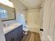Updated bathroom with granite vanity, subway tile, and shower over tub with white tile surround at 8809 Reedy Creek Rd, Charlotte, NC 28215