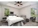 Stylish bedroom featuring trey ceiling, modern decor, two windows, and fan with wood-look blades at 8809 Reedy Creek Rd, Charlotte, NC 28215