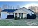 Charming single-story home with yellow siding, blue shutters, and a well-manicured front lawn at 8809 Reedy Creek Rd, Charlotte, NC 28215