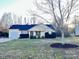 Inviting single-story home with blue shutters, dark roof, fresh landscaping, and a well-maintained lawn at 8809 Reedy Creek Rd, Charlotte, NC 28215