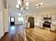 Open kitchen showcasing modern appliances, wood floors, and seamless flow to the living area at 8809 Reedy Creek Rd, Charlotte, NC 28215