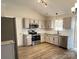 Spacious kitchen featuring stainless steel appliances, granite countertops, and wood flooring at 8809 Reedy Creek Rd, Charlotte, NC 28215