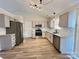 Spacious kitchen featuring stainless steel appliances, granite countertops, and wood flooring at 8809 Reedy Creek Rd, Charlotte, NC 28215