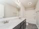 Bathroom featuring a dual sink vanity, a large mirror, and a shower-tub combination at 9127 Colwick Hill Ln, Charlotte, NC 28215