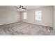 Large bedroom with two bright windows, ceiling fan, plush carpet and neutral walls at 9127 Colwick Hill Ln, Charlotte, NC 28215
