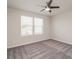 A spacious bedroom featuring carpet floors, a ceiling fan, and two large windows at 9127 Colwick Hill Ln, Charlotte, NC 28215
